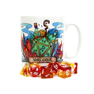 May include: A white ceramic mug with a colorful illustration of a 20-sided die, potions, and crystals. The mug has the word "SORCERER" printed on it. The mug is surrounded by eight red and orange dice.