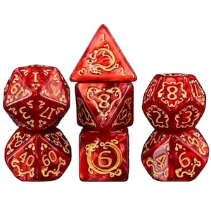 May include: A set of seven red and gold polyhedral dice. Each die has gold numbering and decorative accents. The dice are arranged in a vertical stack, showcasing various shapes including a d20, d12, d10, d8, d6, d4, and a d3.