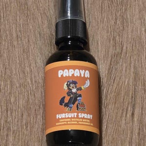 May include: A black spray bottle with a black cap and a label that reads "Papaya Fursuit Spray." The label features a cartoon character and the text "Contains: Distilled Water, Isopropyl Alcohol, Fragrance Oil."