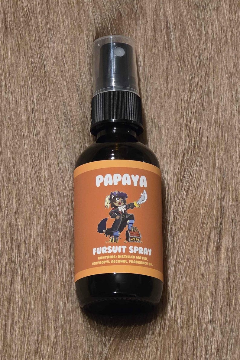 May include: A black spray bottle with a black cap and a label that reads "Papaya Fursuit Spray." The label features a cartoon character and the text "Contains: Distilled Water, Isopropyl Alcohol, Fragrance Oil."