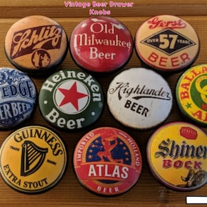 May include: Nine vintage beer bottle cap drawer knobs with various beer brand logos, including Schlitz, Old Milwaukee Beer, Gerst Beer, Gilt Edge Lager Beer, Heineken Beer, Highlander Beer, Ballantine's Ale, Guinness Extra Stout, Atlas Beer, and Shiner Bock.