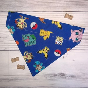 May include: Blue fabric dog collar with a colorful Pokemon print. The print features various Pokemon characters, including Pikachu, Bulbasaur, and Squirtle.