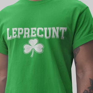 A man wearing a green t-shirt with the text "LEPRECUT" and a white clover symbol printed on it.