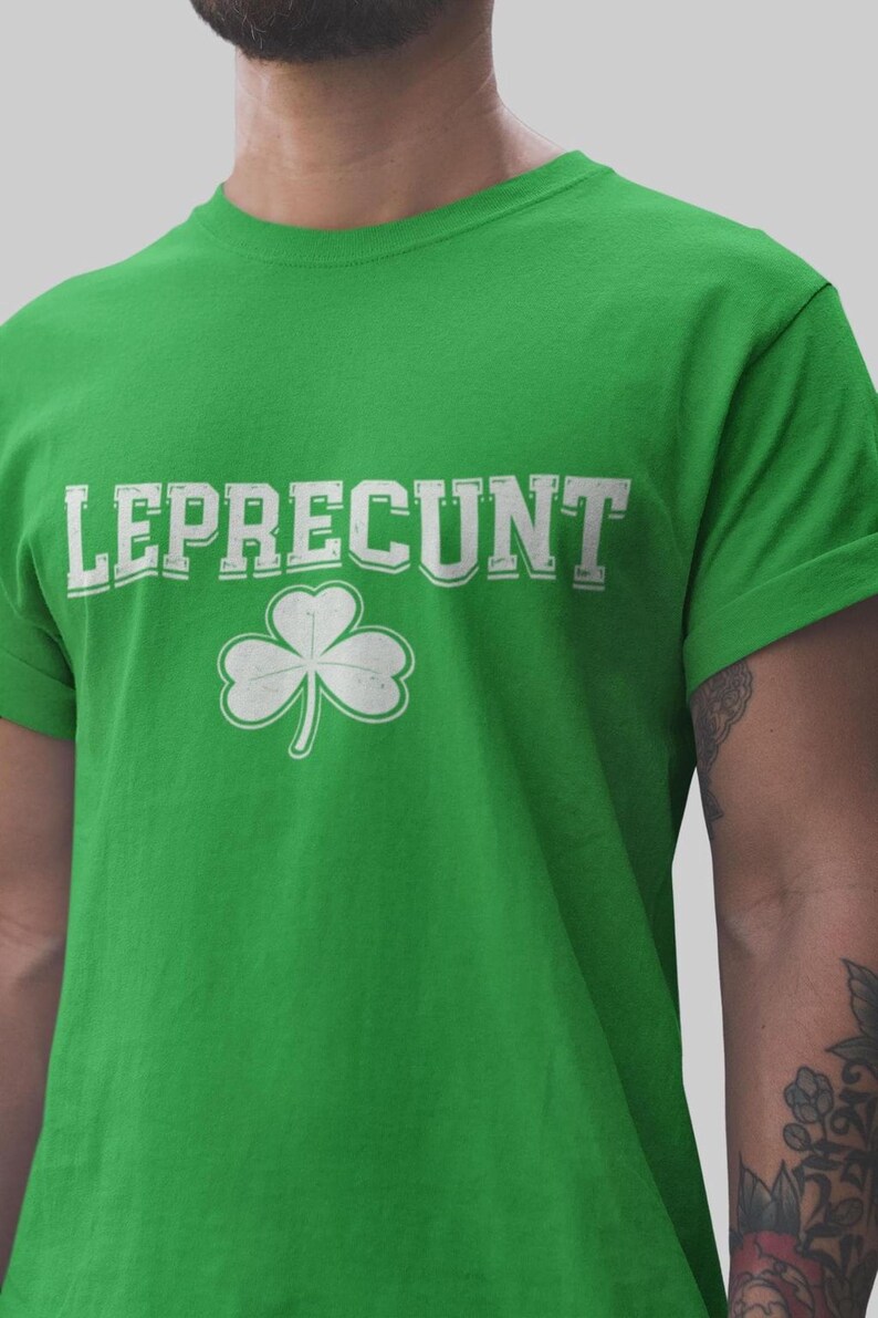 A man wearing a green t-shirt with the text "LEPRECUT" and a white clover symbol printed on it.