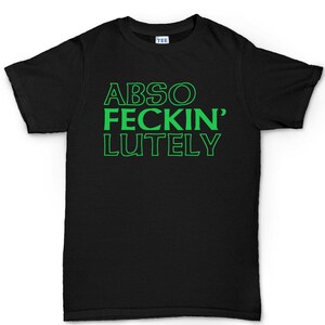 May include: Black t-shirt with the words "ABSO FECKIN' LUTELY" in bright green block letters. The shirt has a crew neck and short sleeves. The word "TEE" is printed on the tag.