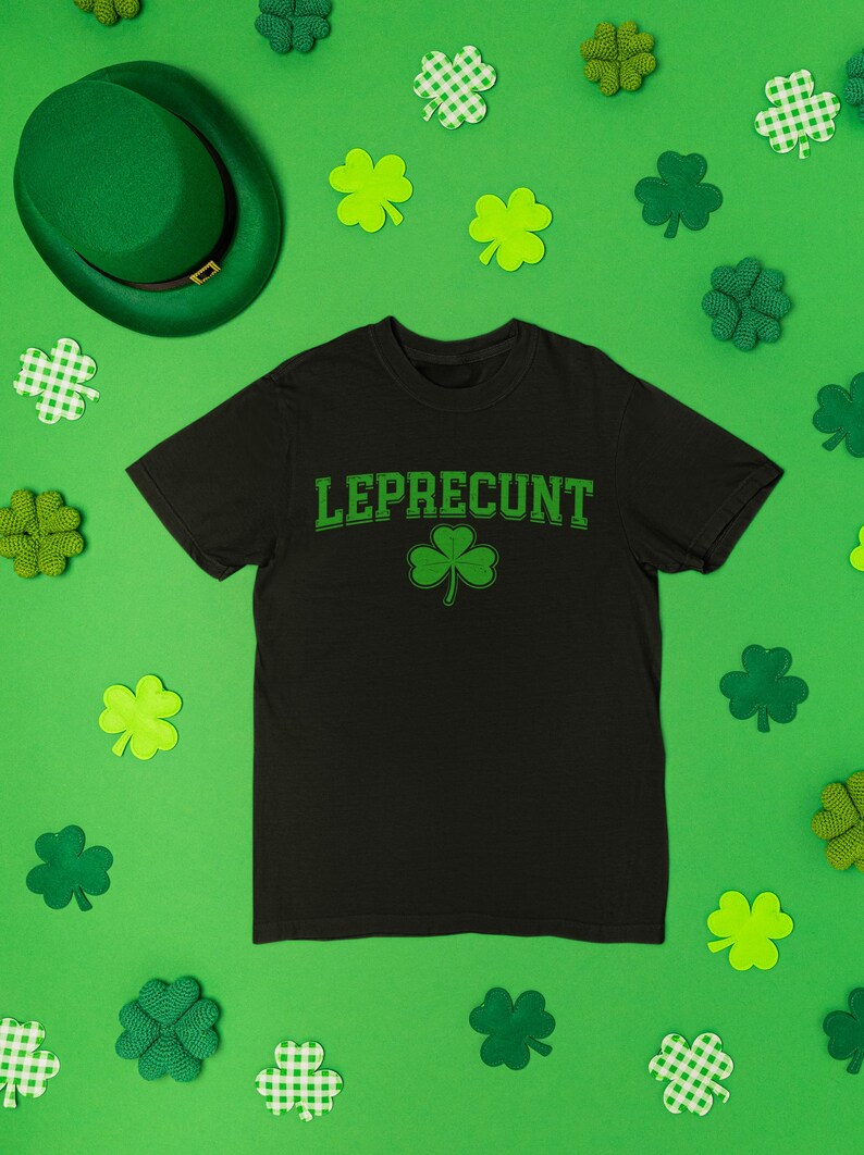 a black t-shirt with the word "Leprecht" printed on it, surrounded by various Leprecht-themed items such as shamrocks, hats, and other accessories.