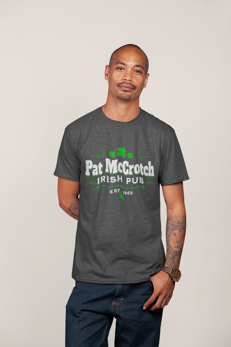 A man wearing a grey t-shirt with the text "Pat McCroch Irish Pub EST 1869" printed on it.