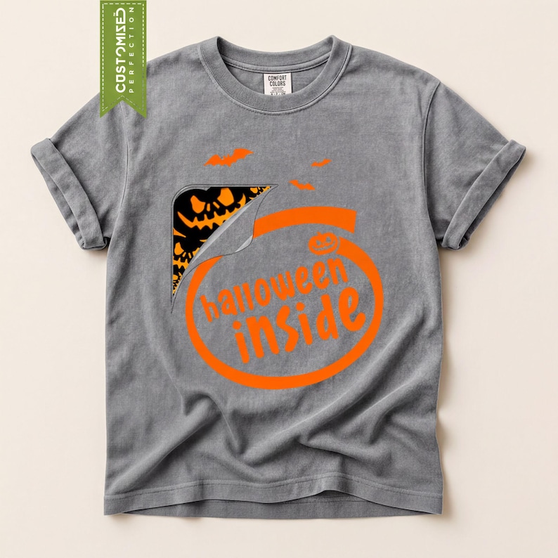 A gray t-shirt with an orange graphic design that says "Halloween inside" and features a pumpkin and bats.
