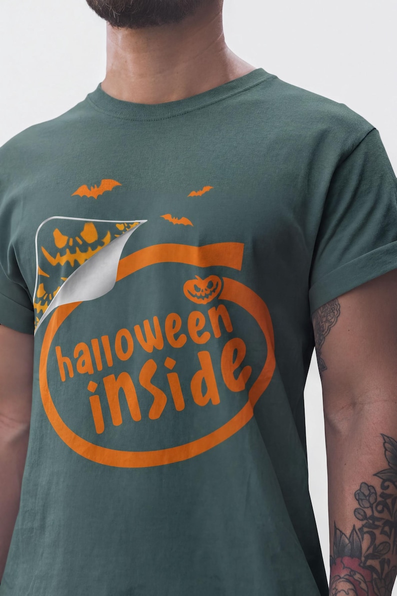 A person wearing a green t-shirt with the text "Halloween inside" printed on it.