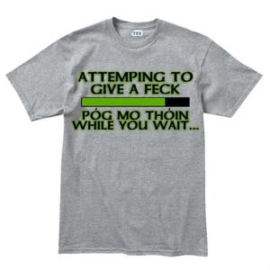 A gray t-shirt with a humorous text printed on it.