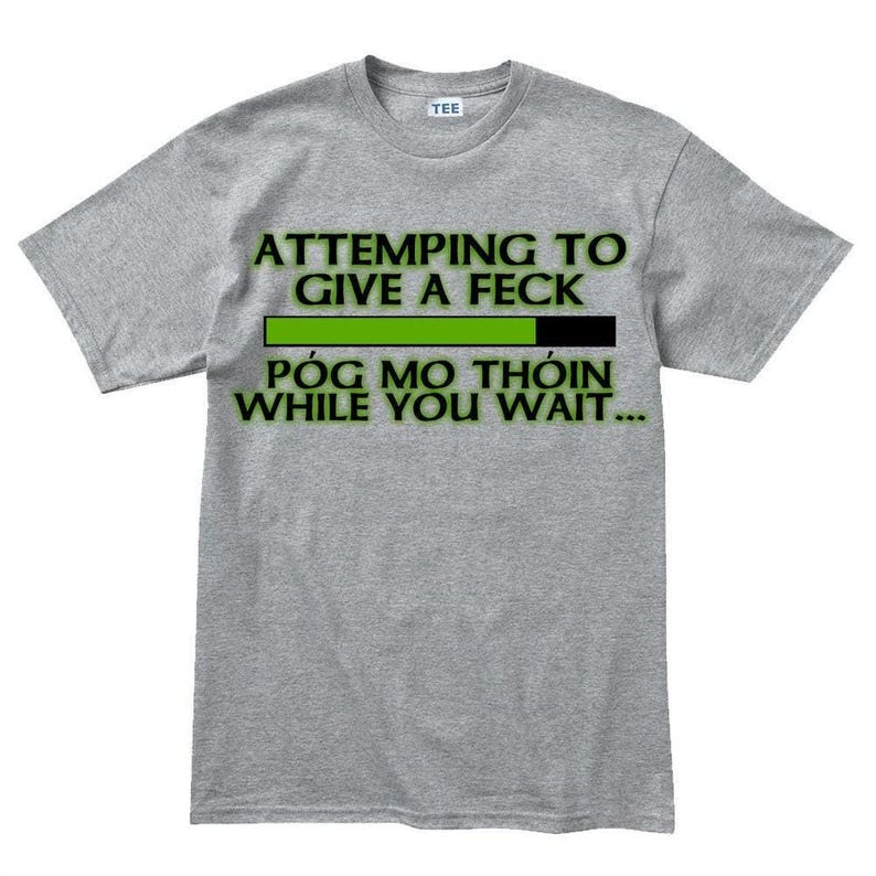 A gray t-shirt with a humorous text printed on it.