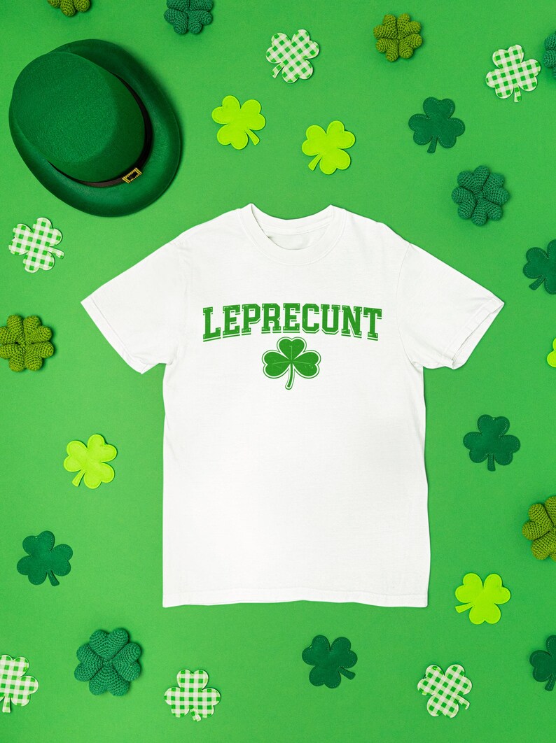a white t-shirt with the word "Leprecht" printed on it, surrounded by various Leprecht-themed items such as shamrocks, hats, and other accessories.