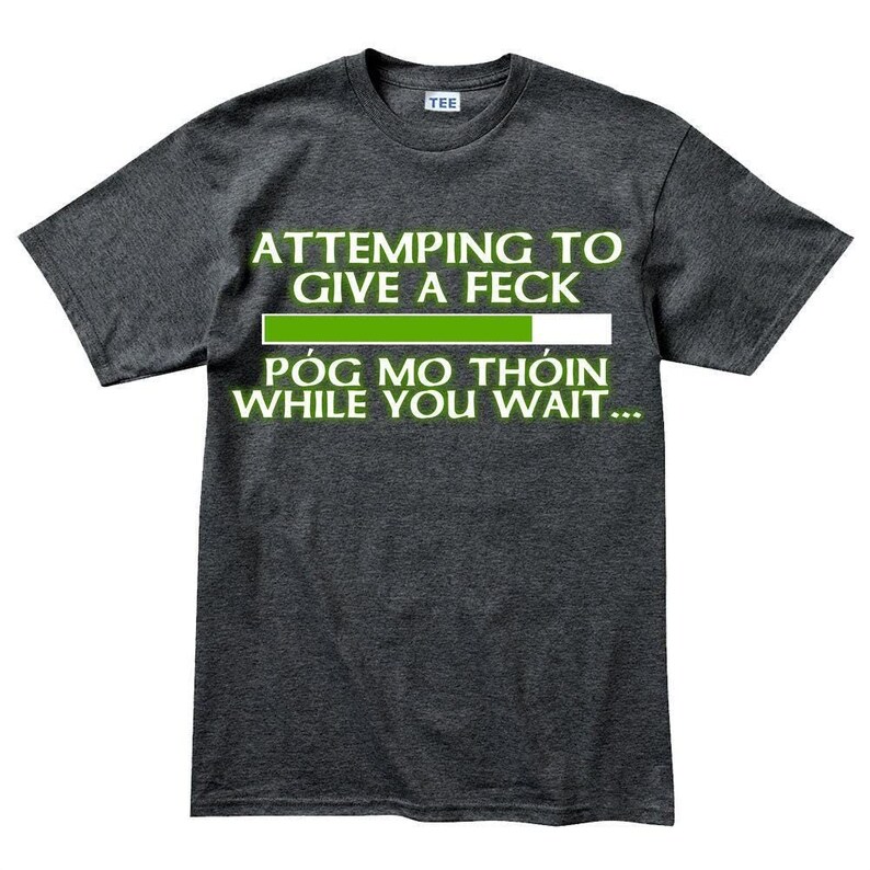 A gray t-shirt with a humorous text printed on it.