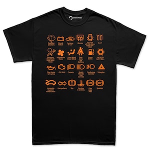 May include: Black t-shirt featuring orange car dashboard warning light graphics with funny text. Phrases include "Squishy Doofers," "Oh Shit!," and "The key is sinking." A humorous and distinctive graphic tee.