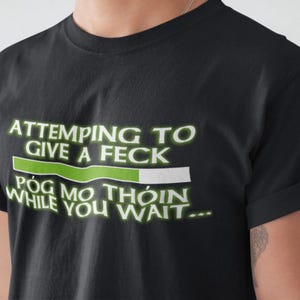 A black t-shirt with a humorous text printed on it.