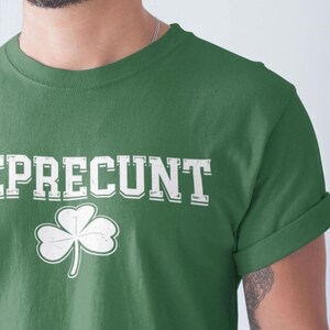 A man wearing a green t-shirt with the word "REPRENT" printed on it.