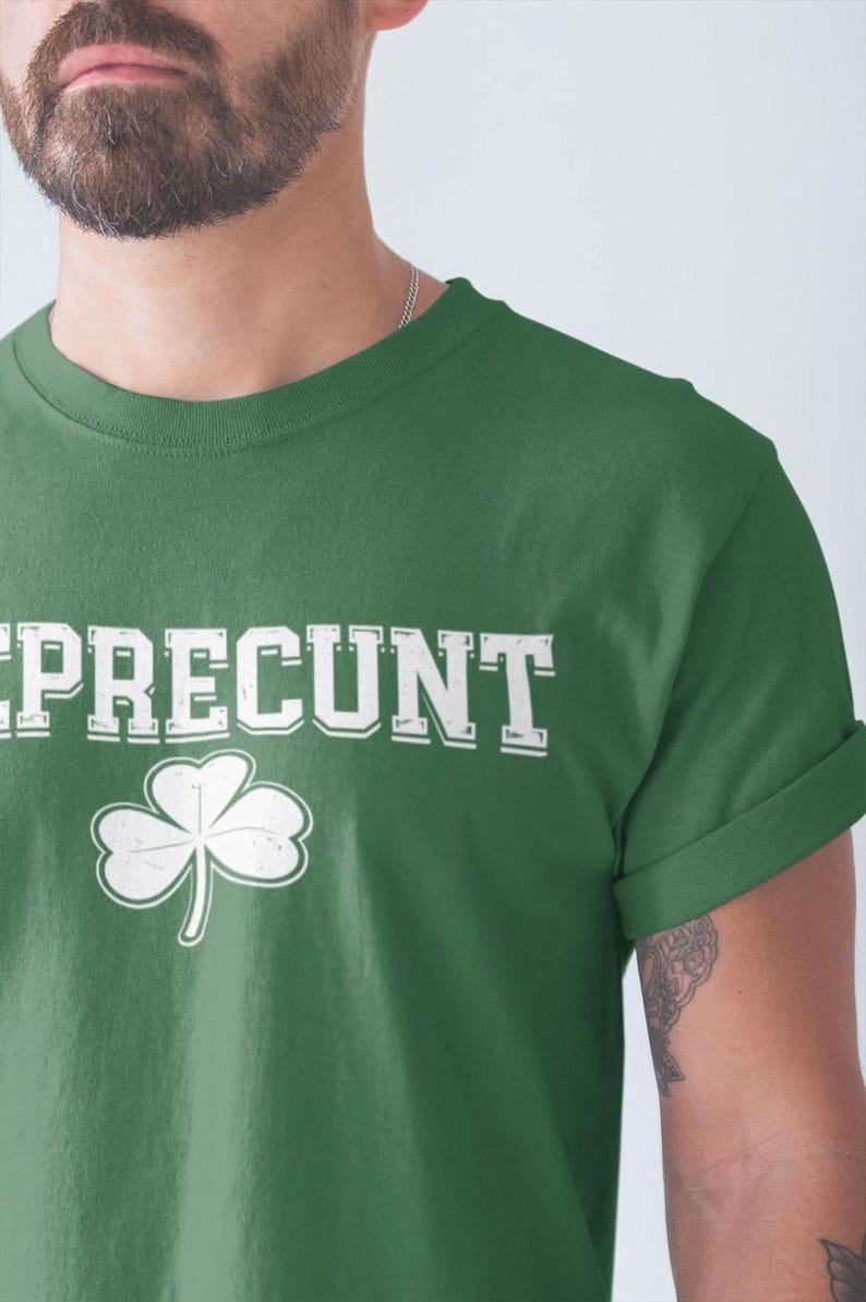 A man wearing a green t-shirt with the word "REPRENT" printed on it.