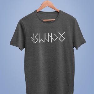 A gray t-shirt with white text printed on it, hanging on a wooden hanger against a blue background.