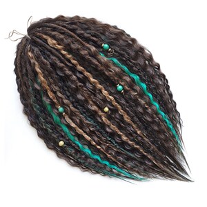May include: Brown and blonde synthetic dreadlocks with teal accents and beads.