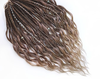30 DE dreads with long curly hair ends, medium brown to natural blonde ombre dreadlocks, adorned with blue decorations and braided accents.