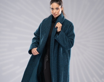May include: A teal blue long coat with a shawl collar and pockets. The coat is made of a soft, textured fabric.