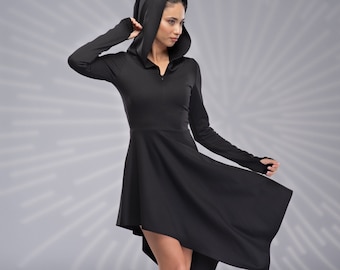 May include: A black hooded dress with a long zip and a high-low hemline. The dress is worn with black lace-up boots.
