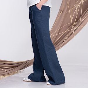 May include: A pair of wide-leg, dark blue linen trousers. The trousers have a relaxed fit and are made from a lightweight, breathable fabric.