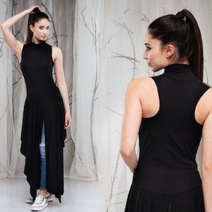 May include: A black sleeveless mock neck tunic with a high-low hemline. The tunic has a slit in the front and is made of a soft, stretchy fabric.