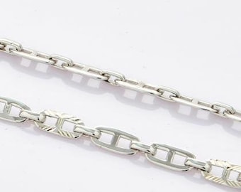 May include: Two silver chains, one with a simple link pattern and the other with a more intricate, textured, mariner link pattern.