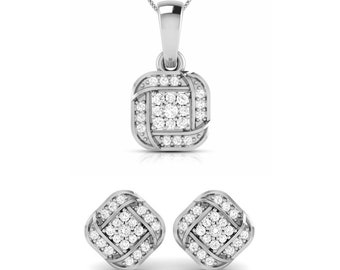 May include: A silver necklace and earrings set with a square pendant and matching earrings. The pendant and earrings feature a knot design with small clear stones.