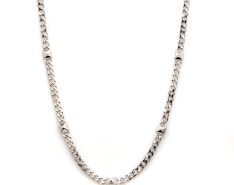 May include: A silver chain necklace with five square-shaped accents.