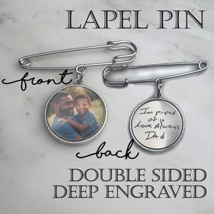 May include: Double-sided lapel pin with a photo on one side and engraved text on the other. The front shows a photo of a man and a child. The back is engraved with the words "I'm proud of u Love Always Dad."