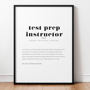 May include: A framed wall print featuring a dictionary-style definition of the term test prep instructor. The text includes the noun, descriptors strategic, motivational, and relentless, and a paragraph describing the role, ending with see also: confidence builder.
