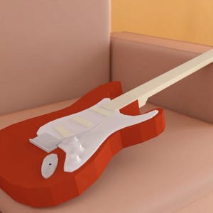May include: A red electric guitar with a white pickguard and a cream-coloured neck. The guitar is lying on a light pink sofa.