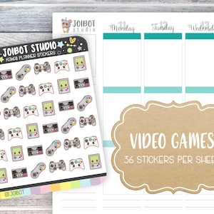 May include: A sheet of kawaii planner stickers from Joibot Studio featuring video game-themed designs. The stickers include game consoles, controllers, and handheld game systems. The sheet also includes a planner layout with the days of the week.