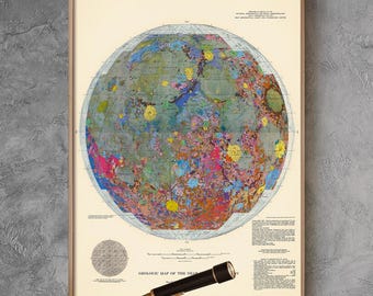 May include: A vintage map of the moon in a wooden frame hangs on a gray wall. A brass telescope on a tripod sits on a wooden table with a brown leather suitcase next to it. A green velvet armchair sits in the corner of the room.
