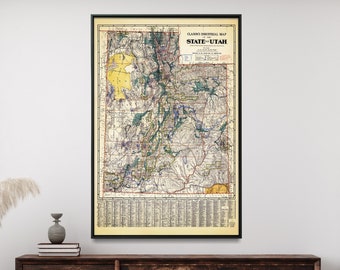 May include: A vintage map of the state of Utah in a black frame hanging on a white wall above a wooden sideboard. The map is in a vintage style with a yellow background and black lines. The map is surrounded by a black frame.