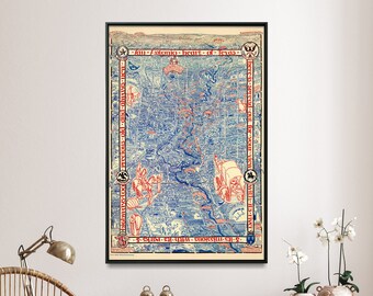 May include: A vintage map of the city of Iowa, printed in blue and red on a white background. The map is framed in a black frame and hangs on a white wall. The map is titled "The Growing Heart of Iowa".