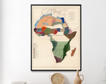May include: A vintage map of Africa showing the natural history of the continent. The map is printed in color and features a key with different colored regions representing different geographical features. The map is framed in black and displayed on a wall.