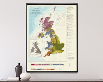 May include: A vintage-style map of Great Britain and Northern Ireland, showing the geological formations of the islands. The map is printed on a light blue background with various colors representing different rock types. The map is framed in black and hanging on a white wall above a wooden dresser.