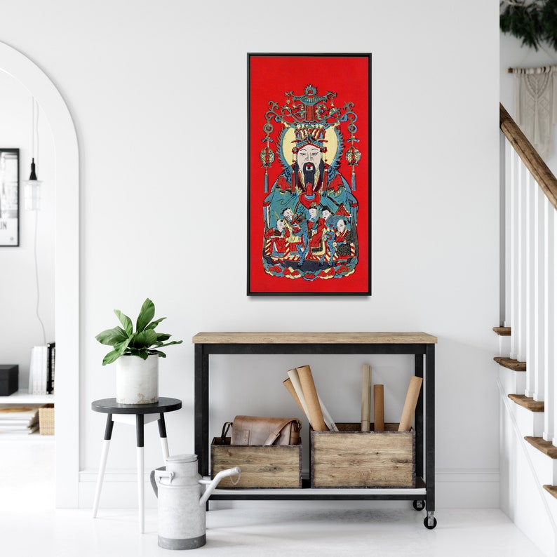 May include: A framed print of a colourful Chinese painting depicting a deity with a long white beard, wearing a red and blue robe, surrounded by other figures. The painting is set against a red background.