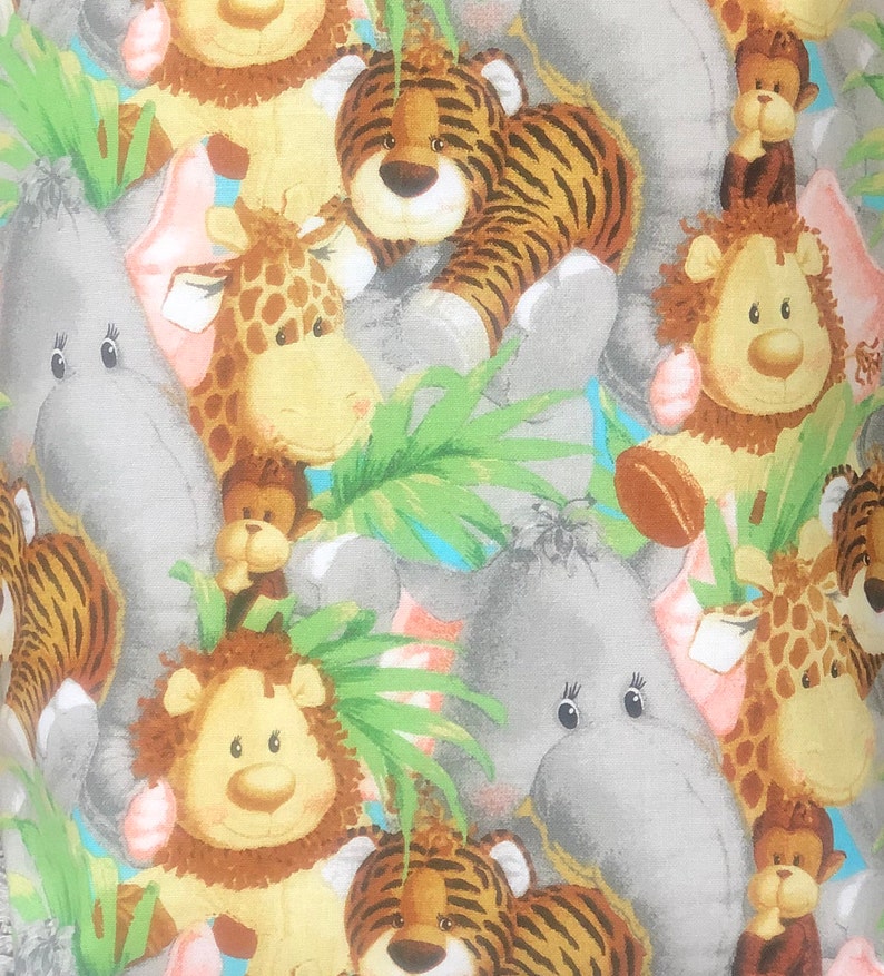 May include: A fabric pattern featuring a repeating illustration of cartoon jungle animals including tigers, giraffes, lions, monkeys, and elephants. The design incorporates green palm leaves and light blue accents against a soft, neutral background.