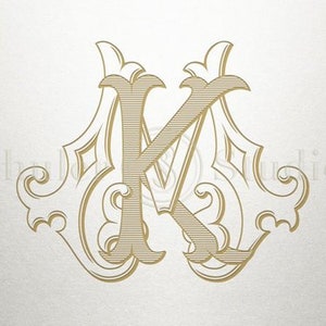 May include: A gold monogram with the letter "K" in a decorative, ornate font. The letter is surrounded by intricate flourishes and swirls.