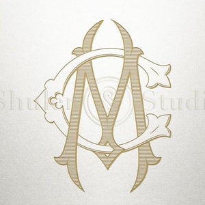May include: A monogram design featuring the letters "A" and "M" intertwined within a decorative circle. The letters are in a gold color and have a vintage style.