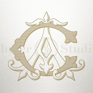May include: A gold monogram with the letters "C" and "A" intertwined in a decorative design. The letters are surrounded by ornate flourishes and a pointed crown.