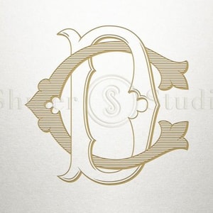 May include: Gold monogram initial letter design with the letters C and C intertwined. The letters are in a decorative, ornate font.