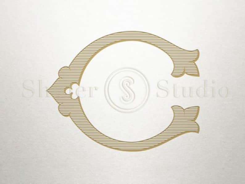 Pu&ograve; includere: Un monogramma iniziale "C" dorato con un design decorativo e ornato. La lettera &egrave; circondata da uno sfondo bianco.