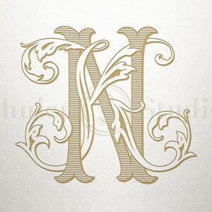 May include: A gold monogram initial letter N with ornate floral flourishes.