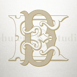 May include: A gold monogram with the letters "E" and "E" intertwined in a decorative, ornate style.
