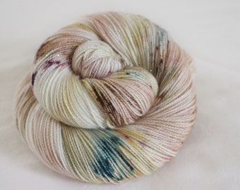 Wrapped Up In Books - Magpie - 75/20/5 superwash merino/ nylon/ gold stellina sock yarn